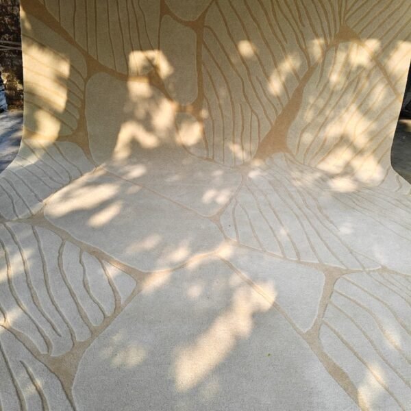 Abstract Hand-Tufted Wool Rug. Featuring a sculpted high-low texture in beige and ivory