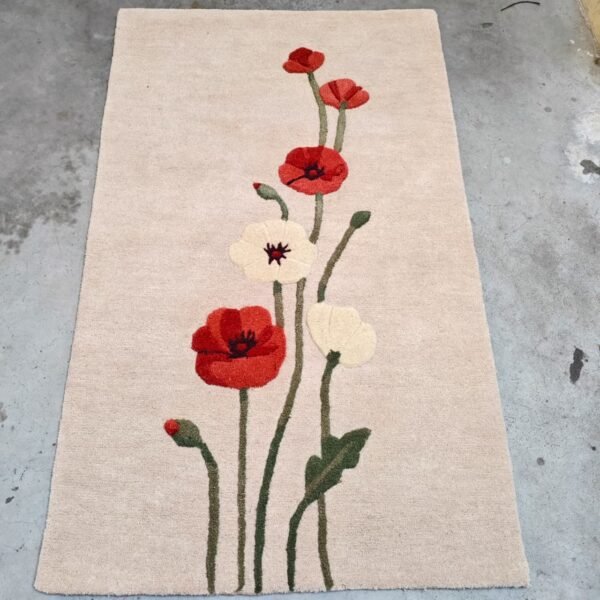 Handmade floral wool rug featuring nature-inspired flowers and soft neutral colors.