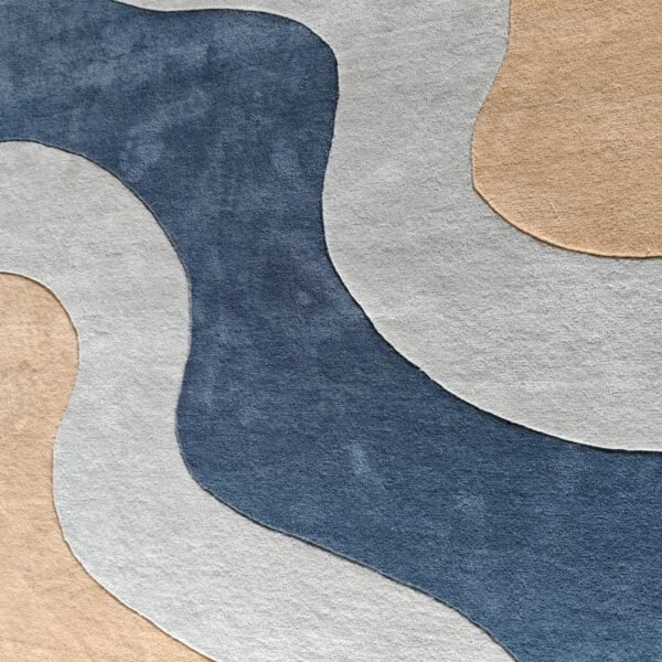 Modern abstract wool area rug featuring curved organic forms in slate blue and cream.