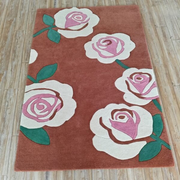 Rose Floral Wool Rug with oversized pink and ivory roses on a terracotta background.